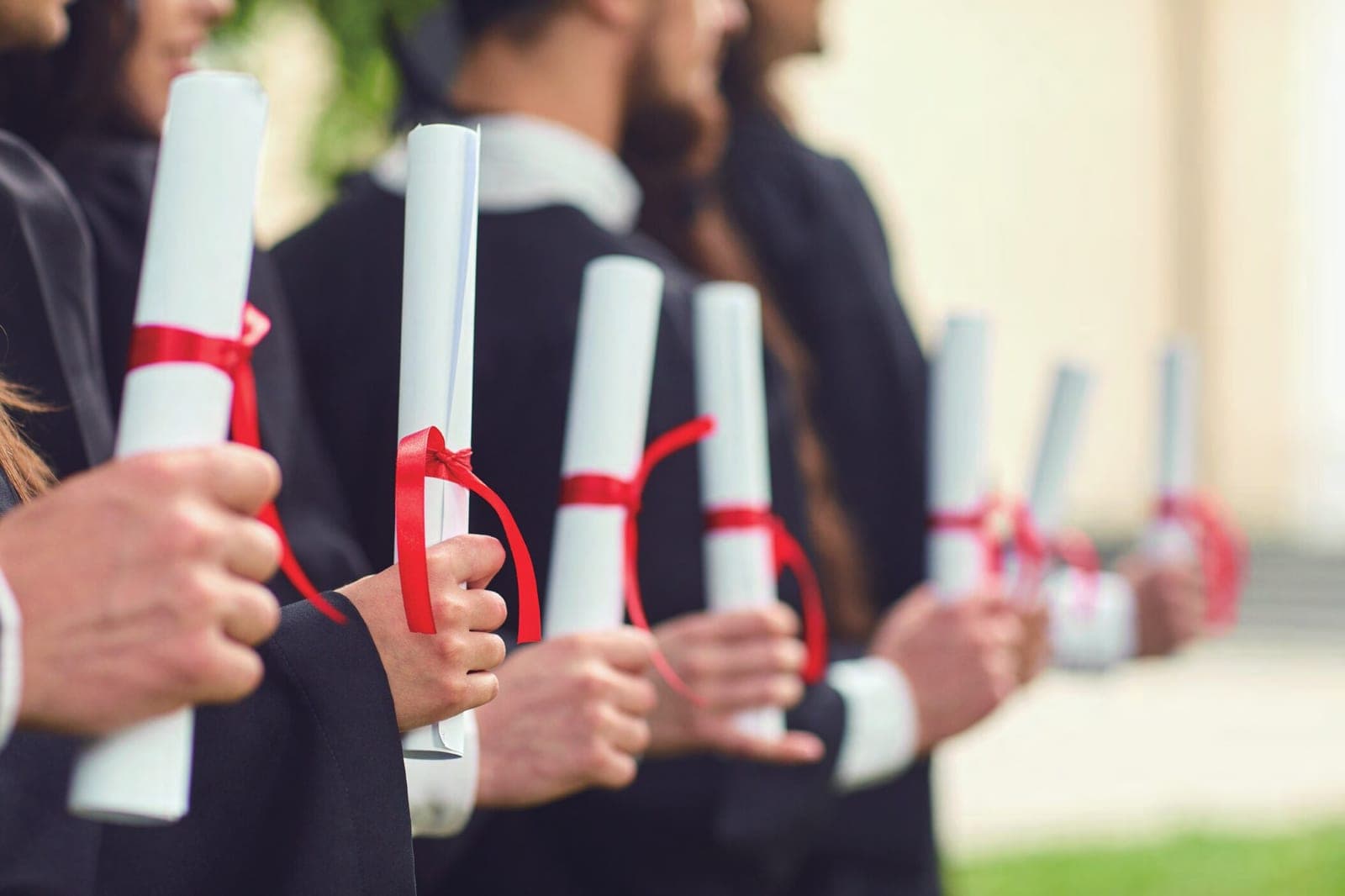 Graduates holding their diplomas